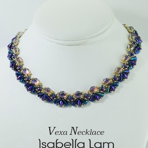 May include: A purple and gold beaded necklace with a crystal-like design. The necklace is on a white mannequin bust. The text "Vexa Necklace Isabella Lam New Thinking with Endless Possibilities" is below the necklace.