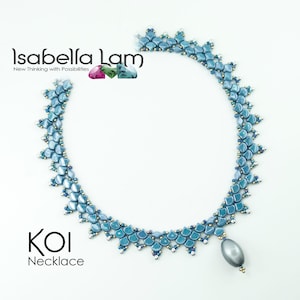 May include: A blue and silver beaded necklace with a teardrop-shaped pendant. The necklace is called "KOI Necklace" and is designed by Isabella Lam.