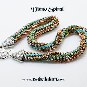 Könnte beinhalten: Eine türkisfarbene, kupferne und goldene Perlenkette mit einem silbernen Verschluss. Die Kette heißt "Dimmo Spiral" und ist auf www.isabellalom.com erhältlich.