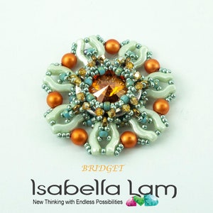 May include: A green and orange beaded flower with a large, faceted, amber-colored crystal in the center. The flower is surrounded by smaller beads and has a delicate, intricate design.