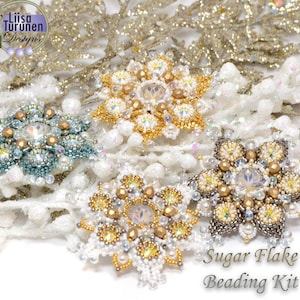 May include: A close-up of a beaded snowflake ornament kit. The kit includes four different snowflake designs, each with a different color scheme. The snowflakes are made with beads and crystals, and they are all very sparkly. The kit is called "Sugar Flake Beading Kit".