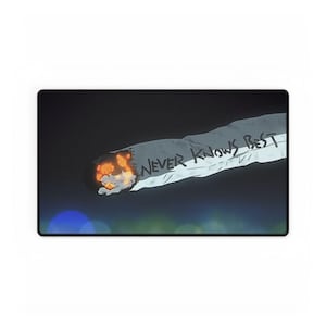 May include: A rectangular desk mat featuring a graphic illustration of a lit cigarette against a dark background. The cigarette has a glowing orange ember at the tip and the text NEVER KNOWS BEST written in black ink along the side of the white paper.