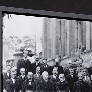 Puede incluir: Fotograf&iacute;a enmarcada en blanco y negro de un grupo de hombres y una mujer con trajes y vestimenta formal, posando frente a un gran edificio. La imagen es un retrato hist&oacute;rico.