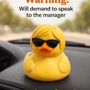 May include: A yellow rubber duck wearing black sunglasses, with blonde hair, and an orange beak. The text on the image reads "Karen Duck! Warning: Will demand to speak to the manager." The duck is heat resistant, sun proof, and has a durable design.
