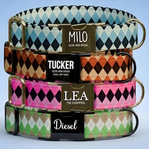May include: Four stacked pet collars featuring argyle patterns in blue, orange, pink, and green. Each collar has a metal or plastic buckle engraved with names like Milo, Tucker, Lea, and Diesel, along with phone numbers and text like Call My Dad.