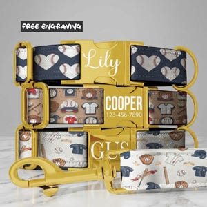 May include: Three pet collars with gold-tone metal buckles. The top collar is navy blue with white baseball-themed hearts and the name Lily. The middle collar is tan with baseball gear and the name Cooper with 123-456-7890. The bottom is white with baseball gear and the name Gus.