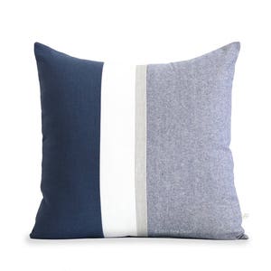 May include: A blue and white striped throw pillow with a subtle gray stripe. The pillow is made of a soft, textured fabric.
