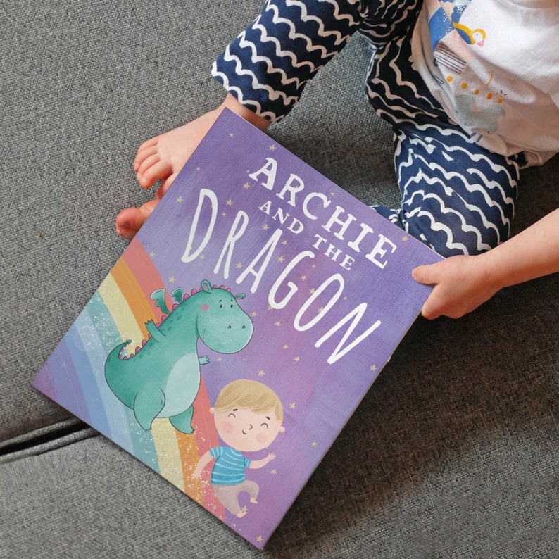 May include: A purple children's book titled "Archie and the Dragon" with a green dragon and a boy with blonde hair on the cover.