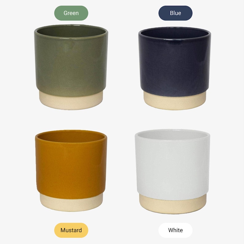 May include: Four ceramic plant pots in different colors: green, blue, mustard yellow, and white. Each pot has a white base.