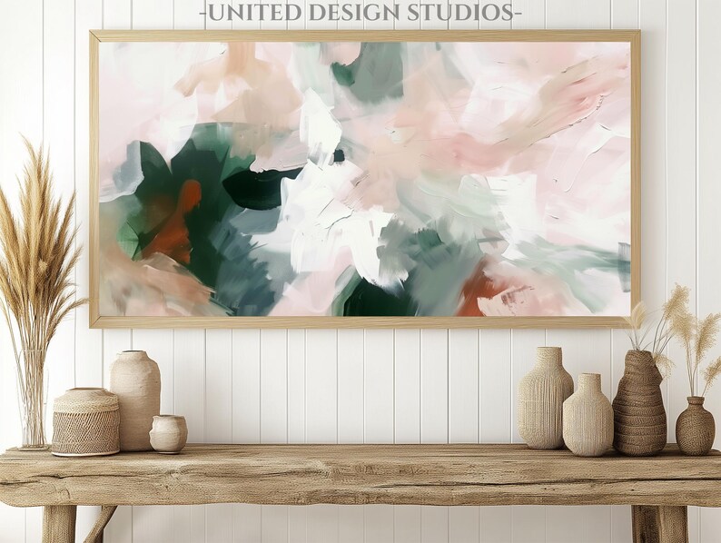 May include: Abstract painting in shades of pink, green, and brown. The painting is framed in a light wood frame and is hanging on a white wall.