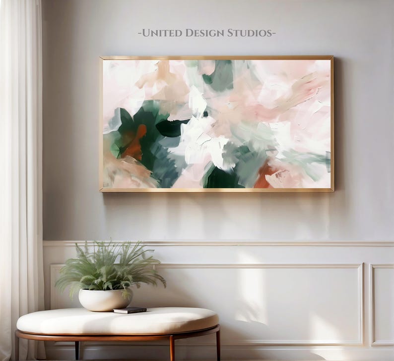 May include: Abstract painting with a gold frame. The painting features shades of pink, green, and white. The painting is hanging on a white wall.