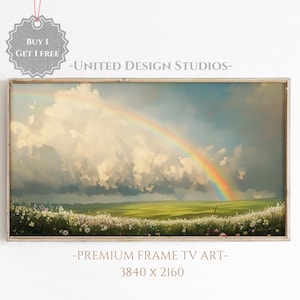 May include: A framed print of a landscape painting featuring a rainbow over a field of white flowers. The sky is a light blue with fluffy white clouds. The text "BUY 1 GET 1 FREE" and "UNITED DESIGN STUDIOS" is visible in the image.
