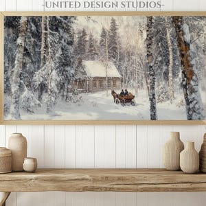 May include: A framed painting of a snowy winter scene with a small cabin in the woods. A horse-drawn carriage is traveling through the snow towards the cabin. The painting is in a light wood frame.
