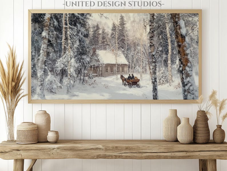 May include: A framed painting of a snowy winter scene with a small cabin in the woods. A horse-drawn carriage is traveling through the snow towards the cabin. The painting is in a light wood frame.