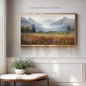 May include: A painting of a misty mountain landscape with a field of wildflowers in the foreground. The mountains are a soft blue and purple, and the sky is a pale blue. The wildflowers are a variety of colors, including pink, purple, and yellow.