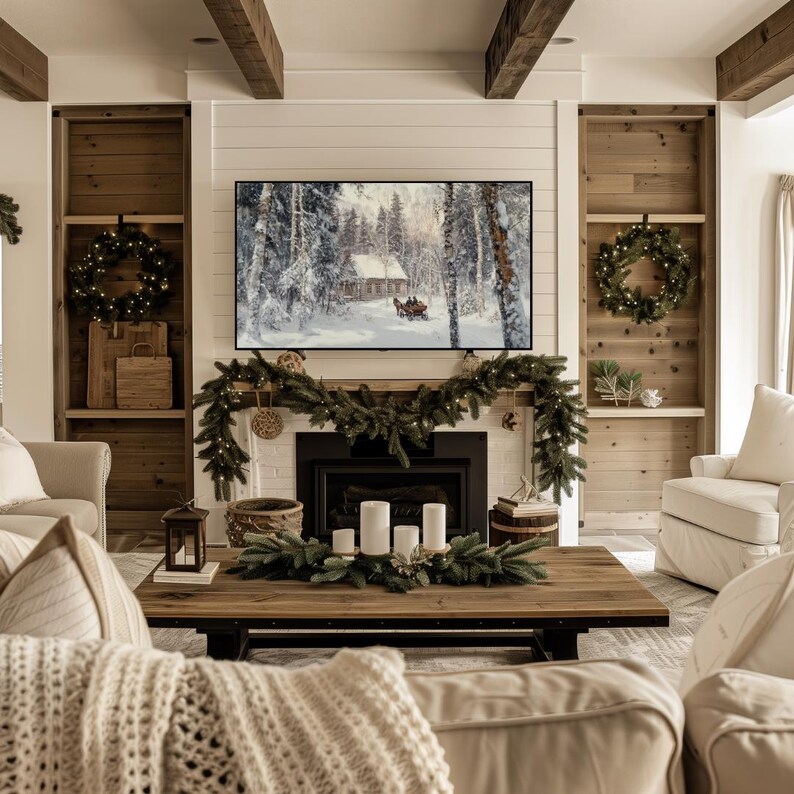 May include: A living room with a white fireplace mantel decorated with a garland of pine branches and white lights. A flat screen TV is mounted above the fireplace. The fireplace is decorated with candles and a wooden bowl. The room is decorated with a white couch and a coffee table.