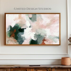 May include: Abstract art print with a pink, white, and green color scheme. The print is framed in a light wood frame and is hanging on a white wall.