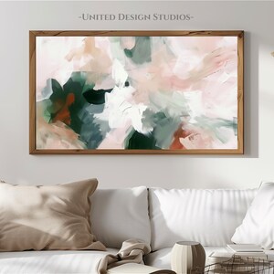May include: Abstract painting in shades of pink, green, and white. The painting is framed in a natural wood frame and is hanging on a white wall.