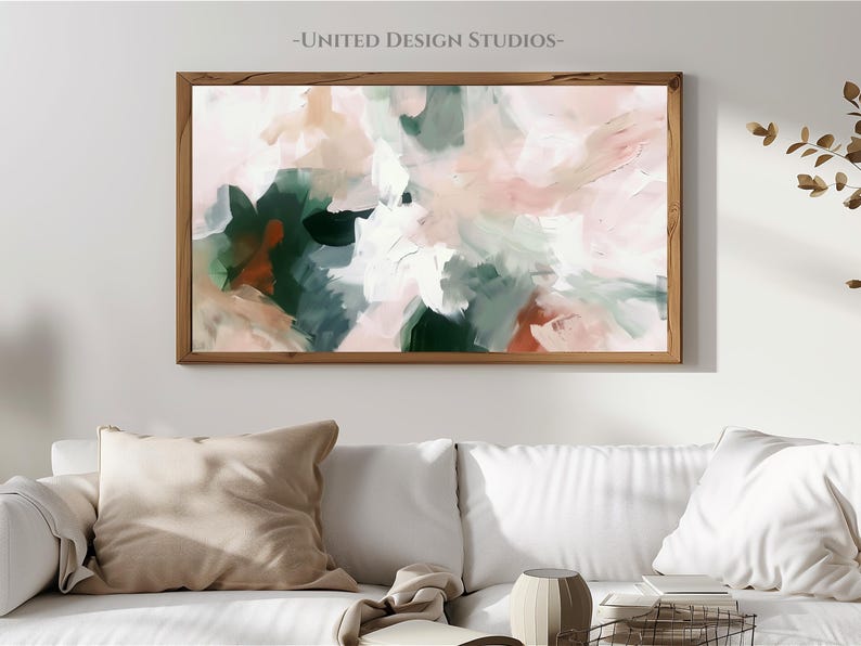 May include: Abstract painting in shades of pink, green, and white. The painting is framed in a natural wood frame and is hanging on a white wall.