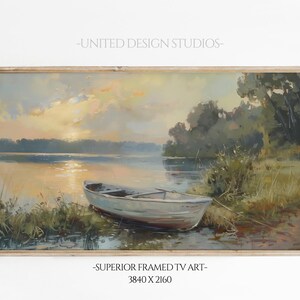 May include: A framed painting of a lake scene with a small white boat in the foreground. The lake is calm and the sky is a soft blue with clouds. The trees on the shore are green and lush. The painting is in a wooden frame.