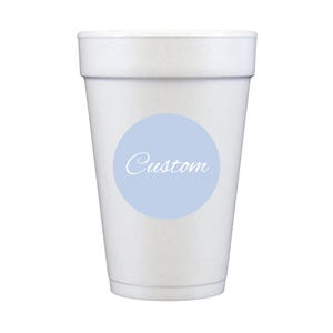 May include: A white foam cup with a light blue circular sticker. The sticker has the word "Custom" in a cursive font. The cup is designed to hold beverages.