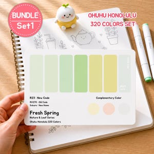 May include: A spiral-bound notebook with a color palette card featuring shades of green and yellow, labeled "Fresh Spring." The card is part of the Ohuhu Honolulu 320 Colors Set. A small, yellow figurine and two white markers are also visible.