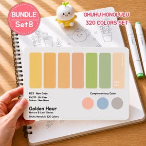 May include: A set of Ohuhu Honolulu 320 Colors markers with a color palette card featuring shades of yellow, orange, and green. The card includes the text "Golden Hour" and "Nature & Leaf Series". A small, yellow figurine sits on a spiral notebook.