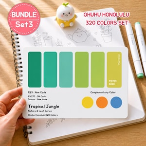 May include: A color palette card from the Ohuhu Honolulu 320 Colors Set, featuring shades of green and complementary colors. The card is labeled "Tropical Jungle" and includes color codes. Two white markers and a small figurine are also present.