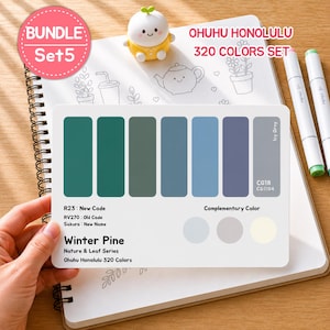 May include: A color palette card from the Ohuhu Honolulu 320 Colors Set, featuring shades of green, blue, and gray. The card includes the text "Winter Pine" and "Nature & Leaf Series". The card is held over a spiral-bound notebook.