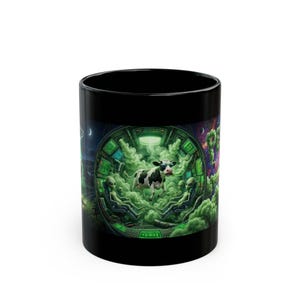 May include: Black ceramic mug featuring a whimsical design of a cow wearing sunglasses inside a spaceship with aliens. The cow is surrounded by green smoke, with a green and black control panel in the background.