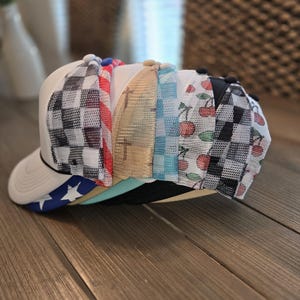 May include: A white ceramic mug with a black handle and the text "But First, Coffee" in a bold, black font. The mug is set against a neutral background, highlighting its simple design.