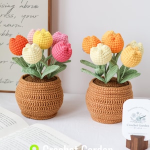 May include: Two crocheted potted tulip arrangements with yellow, orange, pink, and white flowers. The pots are brown and the flowers are in a vase. The image includes the text "Crochet Garden".