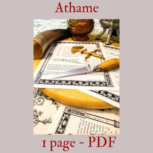 May include: A silver athame with a wooden handle, resting on a white paper with black text and a decorative border. The text reads "Athame" and "Care of Feet".