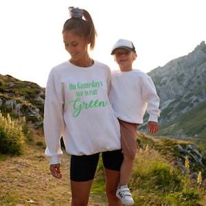 On Gamedays We Wear (Light) Green Sweatshirt: Unisex Crewneck for Sports Fans, Perfect for Celebrations, Game Days, Team Spirit, Casual Wear