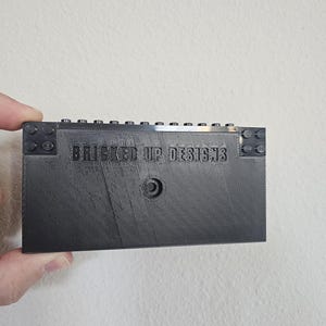 May include: A black 3D printed LEGO brick storage box with the text "BRICKED UP DESIGNS" on the front.
