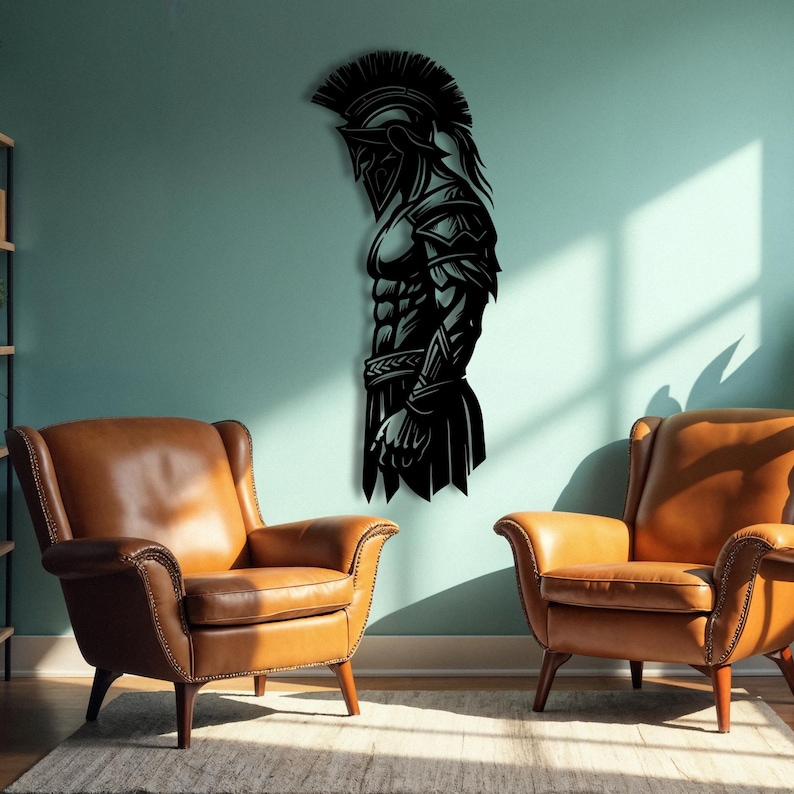 May include: Black metal wall art depicting a Spartan warrior in profile. The artwork features a detailed helmet, armor, and muscular physique. The piece is mounted on a teal wall, with two brown leather armchairs in the foreground.