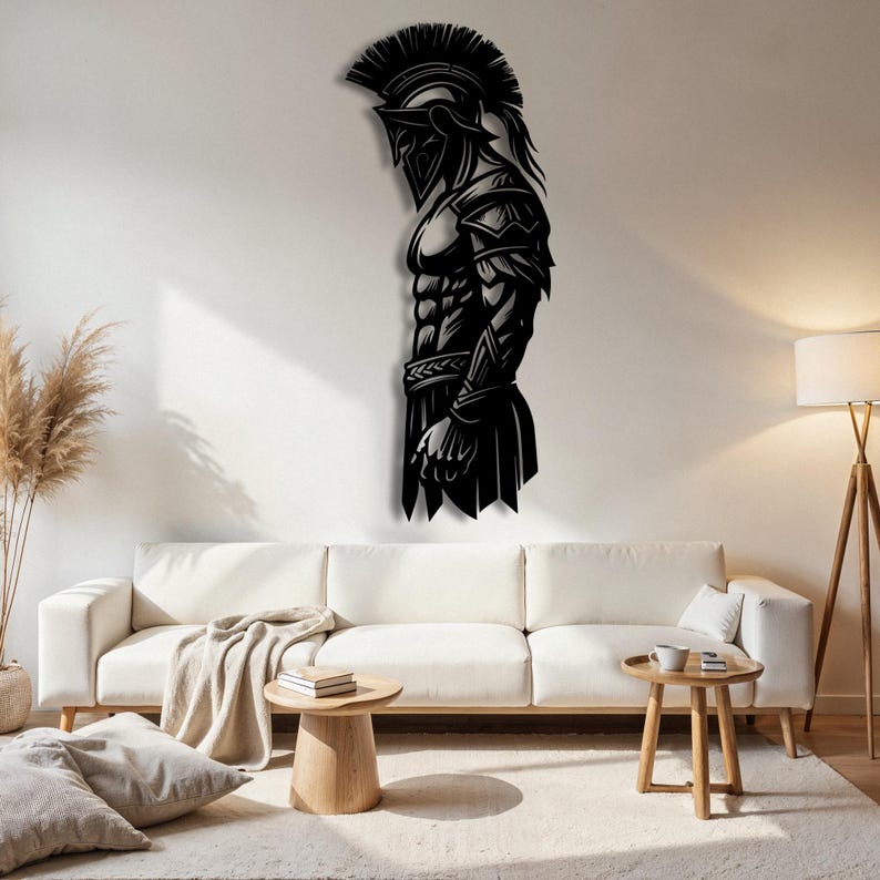 May include: Black metal wall art depicting a Spartan warrior in profile. The artwork features intricate details of the warrior's helmet, armor, and physique. The piece is mounted on a white wall above a white sofa, adding a touch of historical elegance to the room.