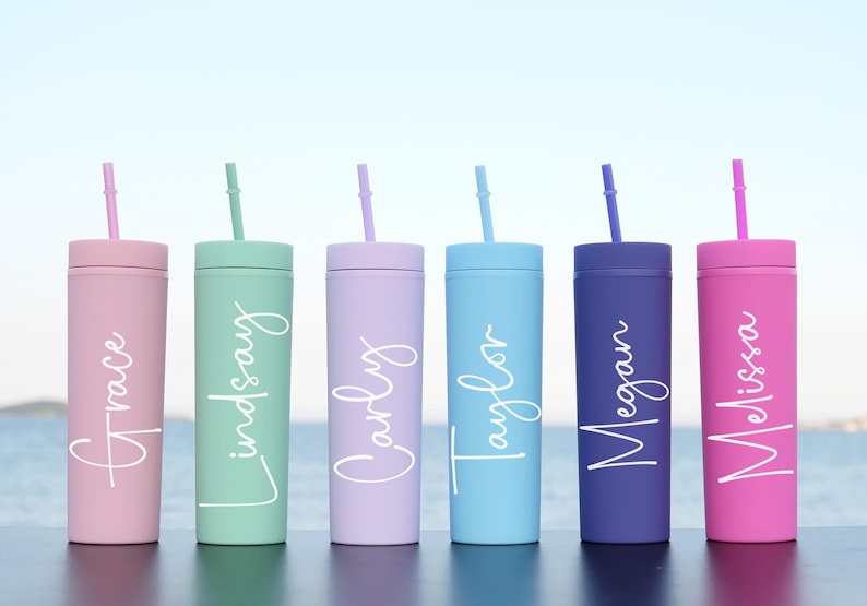 Six different colored tumblers with straws with white text on them