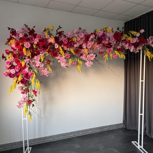 Bright pink yellow ceremony flowers, arch arrangement, flower event decor, birthday backdrop, artificial flower garland, front shop garland
