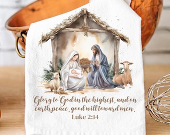 May include: White kitchen towel featuring a Nativity scene with Mary, Joseph, and baby Jesus in a stable. The towel includes the text "Glory to God in the highest, and on earth peace, good will toward men. Luke 2:14."