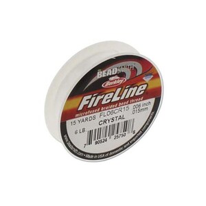 May include: A spool of white FireLine braided bead thread. The label reads "FireLine" and includes the text "15 yards, 6 lb, 0.006 inch, 0.15mm, Crystal". The spool has a red, yellow, and black label.