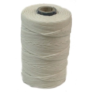 May include: A spool of white cotton thread wound tightly around a cardboard tube.