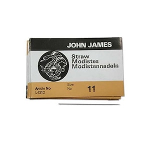 May include: A package of John James Straw Modiste needles, size 11. The package is black with a gold dragon logo and the text "Straw Modiste Modisteennadeln" in black. The package also has a white label with the text "Article No L4312" and "Size No 11".