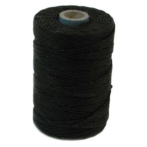 May include: A spool of black waxed cotton thread.