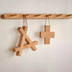 May include: A set of three ceramic mugs with a speckled, matte finish in cream, light brown, and dark brown. Each mug has a simple design and a rounded handle. Suitable for tea or coffee, the mugs have a minimalist aesthetic.