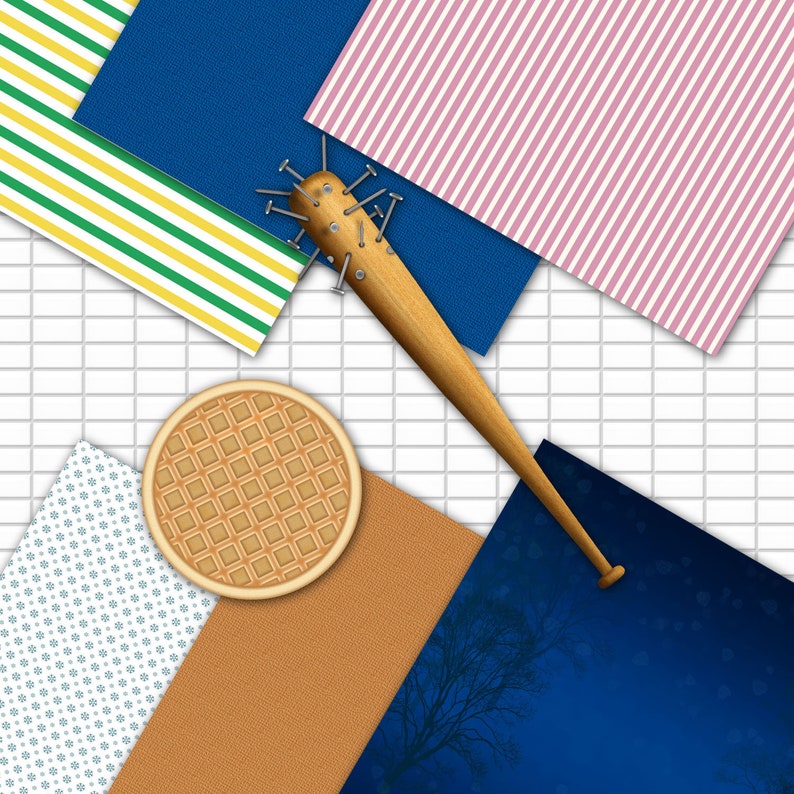 May include: A wooden baseball bat studded with nails, positioned diagonally across a composition of colorful paper backgrounds. A round waffle and various patterned papers in blue, pink, green, and brown complete the arrangement.