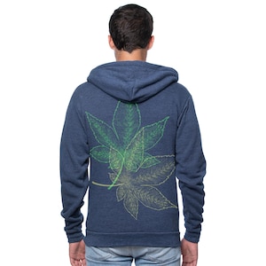 May include: A navy blue zip-up hoodie with a green and yellow cannabis leaf design on the back. The hoodie has a hood and a full-length zipper. The leaf design is a detailed illustration.