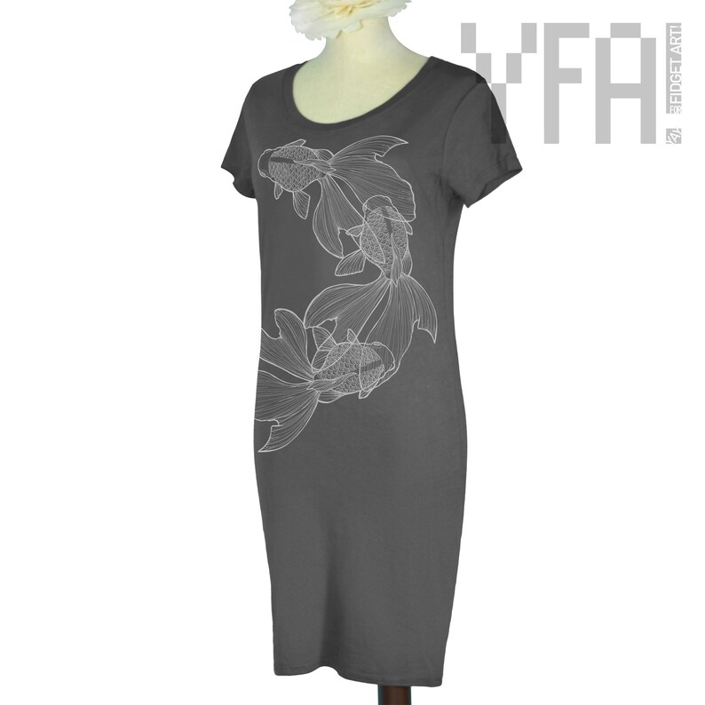 May include: A charcoal gray t-shirt dress with a white outline of three goldfish swimming in a circle on the front.
