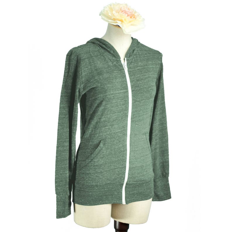 May include: A green heather zip-up hoodie with a white zipper and a hood. The hoodie is on a mannequin.