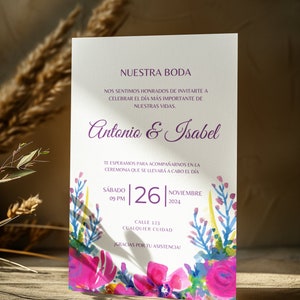 May include: A wedding invitation with a watercolor floral design in shades of pink, blue, and yellow. The invitation reads "Nuestra Boda" and includes the names "Antonio & Isabel", the date "Saturday, November 26, 2024", and the time "09 PM".